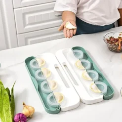 Kompakt manuell dumplingsmaskin med ergonomiskt handtag - platsbesparande design, grön